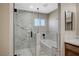 Bathroom featuring a glass-enclosed shower, soaking tub, and marble accents at 1904 Roxbury Ln, Las Vegas, NV 89119