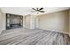 Open living room with a modern fireplace, dark accent wall, wood-look flooring, and neutral walls at 1904 Roxbury Ln, Las Vegas, NV 89119