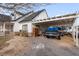 Side view of home with a covered parking area and gravel driveway at 1971 S Manzanita Dr, Pahrump, NV 89048