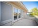 This balcony has white railings, a concrete floor, and a set of white sliding glass doors at 204 N Ring Dove Dr, Las Vegas, NV 89144