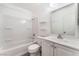 Clean bathroom featuring a tub-shower, white vanity, and minimalist shelving at 228 N Bruce St # D, Las Vegas, NV 89101