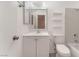 Bathroom featuring a shower-tub combo, white tiled walls, and a modern vanity at 228 N Bruce St # D, Las Vegas, NV 89101