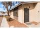 Side view of entrance to home with security door and low maintenance desert landscaping at 228 N Bruce St # D, Las Vegas, NV 89101
