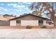 Exterior view of a single story townhome with new gravel landscaping at 228 N Bruce St # D, Las Vegas, NV 89101