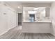 Open-concept living room with kitchen view, and neutral color scheme at 228 N Bruce St # D, Las Vegas, NV 89101