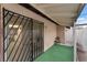 Back patio featuring security door and a partially covered area with green astroturf at 228 N Bruce St # D, Las Vegas, NV 89101