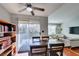 Bright dining area featuring a ceiling fan, hardwood floors, and sliding glass doors leading to a balcony at 2300 E Silverado Ranch Blvd # 2162, Las Vegas, NV 89183