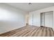 Bedroom with wood floors, white walls, and a closet with sliding doors at 2333 Wooster Cir # B, Las Vegas, NV 89108