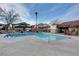 Community pool area with clear blue water and surrounding buildings under a partly cloudy sky at 2333 Wooster Cir # B, Las Vegas, NV 89108