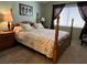 Comfortable bedroom with a four-poster bed, carpeted floors, and natural lighting at 2435 Cliffwood Dr, Henderson, NV 89074