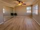 Spacious bedroom featuring natural light, a ceiling fan, and a mirrored closet at 2451 Muirfield Ave, Henderson, NV 89074