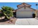 Charming two-story home featuring a low maintenance desert front yard with a two car garage and tile roof at 2451 Muirfield Ave, Henderson, NV 89074