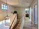 Hallway with wood-look floors, overhead light fixture, window, and views of the bathroom and bedrooms at 2451 Muirfield Ave, Henderson, NV 89074