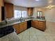 Kitchen features granite countertops, tile floor, stainless steel sink and wooden cabinets at 2451 Muirfield Ave, Henderson, NV 89074