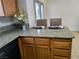 Kitchen island featuring granite counters, wooden cabinets and seating for two at 2451 Muirfield Ave, Henderson, NV 89074