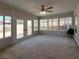 Sunroom featuring large windows, ceiling fan, and neutral-colored carpet at 2451 Muirfield Ave, Henderson, NV 89074