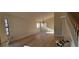 Bright living room with wood floors, a large window, and a modern light fixture at 2451 Muirfield Ave, Henderson, NV 89074