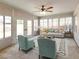 Bright sunroom featuring ample natural light, comfortable seating, and a ceiling fan at 2451 Muirfield Ave, Henderson, NV 89074