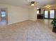 Spacious living room featuring tile flooring, a ceiling fan, and access to the kitchen at 2451 Muirfield Ave, Henderson, NV 89074