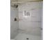 Shower featuring modern tile, a rainfall shower head, and built-in shelving at 2451 Muirfield Ave, Henderson, NV 89074