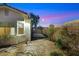 Backyard with desert landscaping, stone pathway, and access to a gated area at 2725 Cool Lilac Ave, Henderson, NV 89052