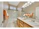 Bathroom with double sinks, vanity, shower-tub combo, and tile floors at 2725 Cool Lilac Ave, Henderson, NV 89052