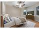 Cozy bedroom featuring wood floors, a ceiling fan, and a large window for ample natural light at 2725 Cool Lilac Ave, Henderson, NV 89052