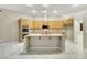Spacious kitchen featuring wood cabinets, granite countertops, and a large center island at 2725 Cool Lilac Ave, Henderson, NV 89052