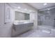 Modern bathroom featuring double sinks, and a glass-enclosed shower with stylish gray tiles at 3205 Antilles Ct, Las Vegas, NV 89117