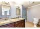 Elegant bathroom featuring double sinks, granite countertops, and a glass-enclosed shower and tub at 3665 S Pointe Cir, Laughlin, NV 89029