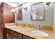 Bathroom with a double sink vanity, granite countertop, and framed mirrors over dark cabinetry at 3665 S Pointe Cir, Laughlin, NV 89029