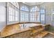 Bathroom features a corner soaking tub with marble and tile, complemented by bright windows at 3665 S Pointe Cir, Laughlin, NV 89029