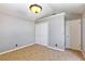 Bedroom with neutral paint, carpet, and trim with a closet with double doors and a white door to another room at 3665 S Pointe Cir, Laughlin, NV 89029