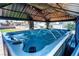 Backyard with a hot tub under a gazebo, complete with water jets, overhead lighting, and manicured landscaping at 3665 S Pointe Cir, Laughlin, NV 89029