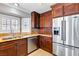 Bright kitchen featuring stainless steel refrigerator, granite counters, and custom wood cabinets at 3665 S Pointe Cir, Laughlin, NV 89029