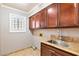Functional laundry room with a granite countertop, ample storage and a window at 3665 S Pointe Cir, Laughlin, NV 89029
