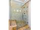 Luxurious walk-in shower features a glass enclosure and bench with elegant tile surround at 3665 S Pointe Cir, Laughlin, NV 89029