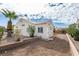 Charming backyard with desert landscaping, brick planters and a mature palm tree at 3721 Brentcove Dr, North Las Vegas, NV 89032