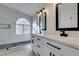 Beautiful bathroom features dual sinks, modern fixtures, and a tiled shower with large window at 3721 Brentcove Dr, North Las Vegas, NV 89032