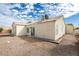 The rear exterior of the house features desert landscaping and a sliding glass door at 3721 Brentcove Dr, North Las Vegas, NV 89032