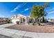 Charming single-story home with a two car garage, neutral paint, desert landscaping, and shade tree at 3721 Brentcove Dr, North Las Vegas, NV 89032