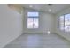 Bright living room with grey floors, all-white walls, and a large window for natural light at 3721 Brentcove Dr, North Las Vegas, NV 89032