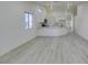 Open concept kitchen and living room area featuring light, wood-look floors and bright light at 3721 Brentcove Dr, North Las Vegas, NV 89032