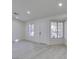 Bright living room with wood-look floors, two windows, and a white door, offering a welcoming space at 3721 Brentcove Dr, North Las Vegas, NV 89032