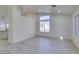 Bright living room with grey floors, all-white walls, and a large window for natural light at 3721 Brentcove Dr, North Las Vegas, NV 89032