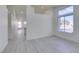 Bright living room with grey floors, all-white walls, and a large window for natural light at 3721 Brentcove Dr, North Las Vegas, NV 89032