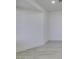 Corner of a living room featuring a large wall, baseboard trim, and light wood-look flooring at 3721 Brentcove Dr, North Las Vegas, NV 89032
