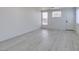 Bright living room features light, wood-look floors, white walls, and windows with natural light at 3721 Brentcove Dr, North Las Vegas, NV 89032