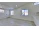 Bright living room features light modern floors, two large windows and a glass insert door at 3721 Brentcove Dr, North Las Vegas, NV 89032