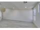 Bright living room features light, wood-look floors, white walls, and windows with natural light at 3721 Brentcove Dr, North Las Vegas, NV 89032